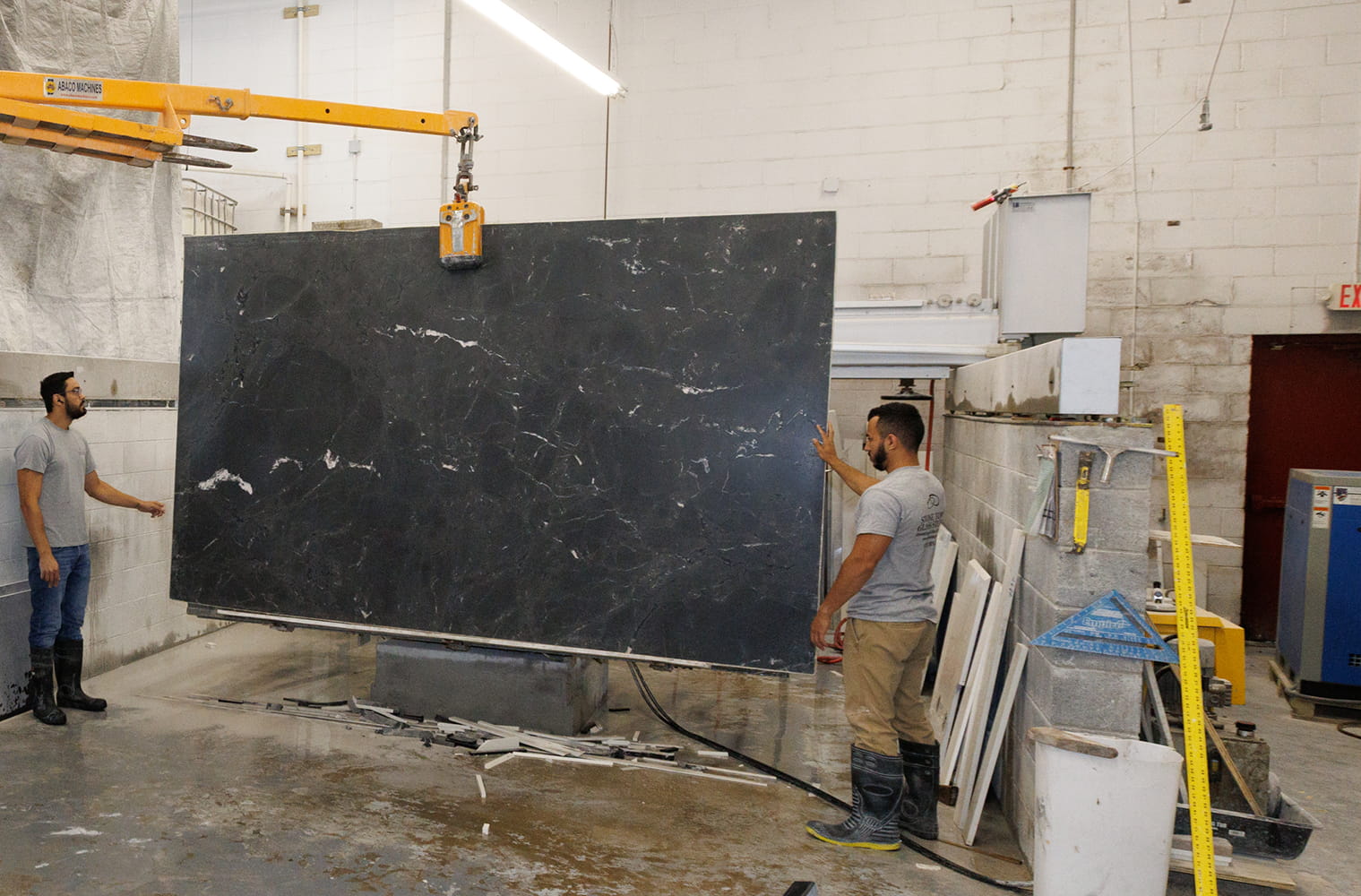 Stone workers fabricating custom granite and quartz countertops using advanced Italian machinery in New Jersey